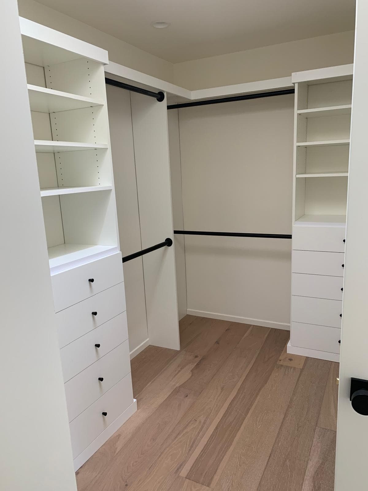 Custom walk-in closet with built-in shelving and hanging rods