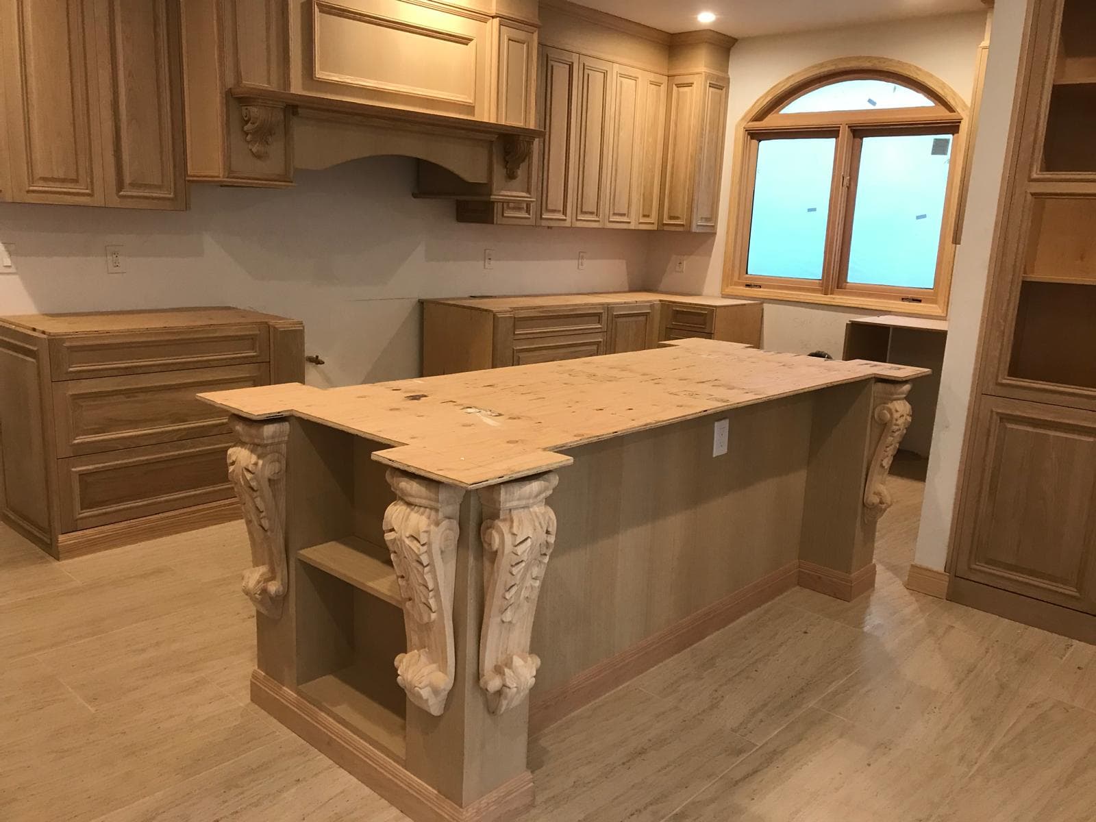 Custom wood kitchen cabinets installed across full wall