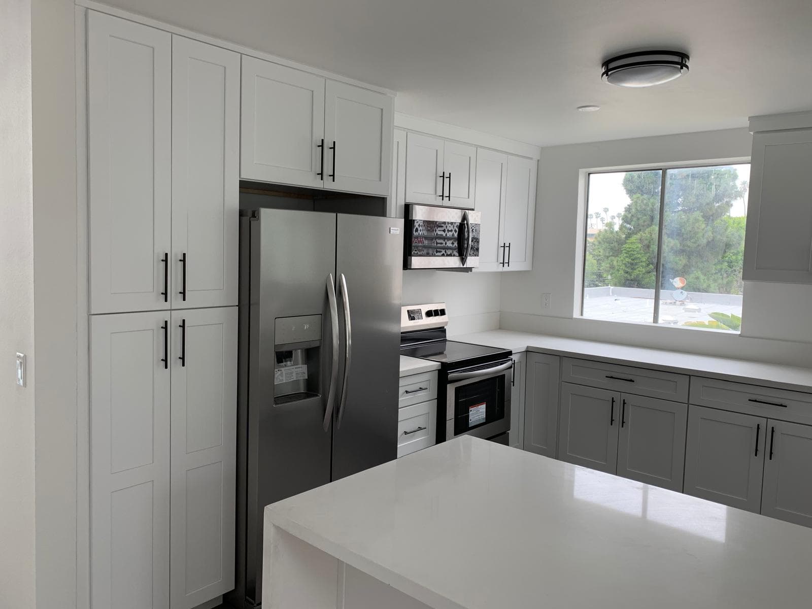 Modern gray shaker kitchen cabinets installed with even reveals