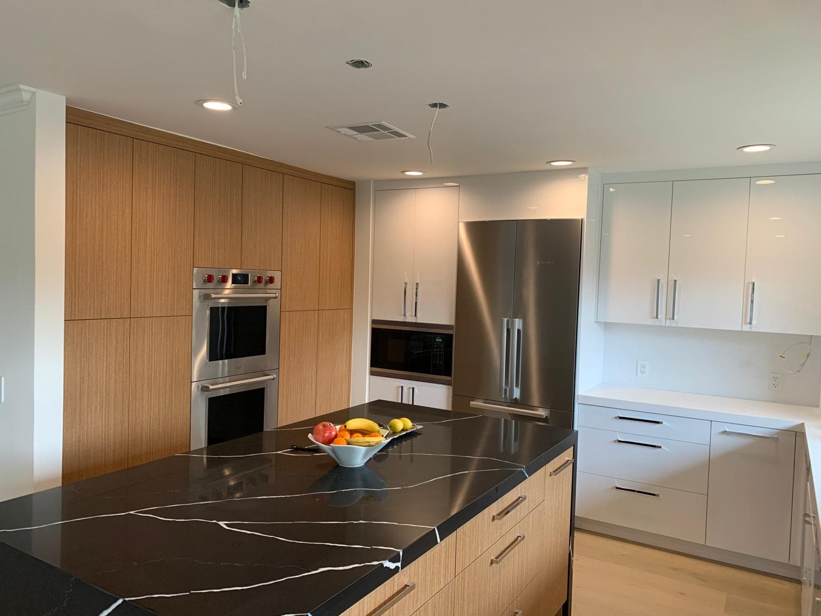 Close-up of black marble island seams and cabinet alignment